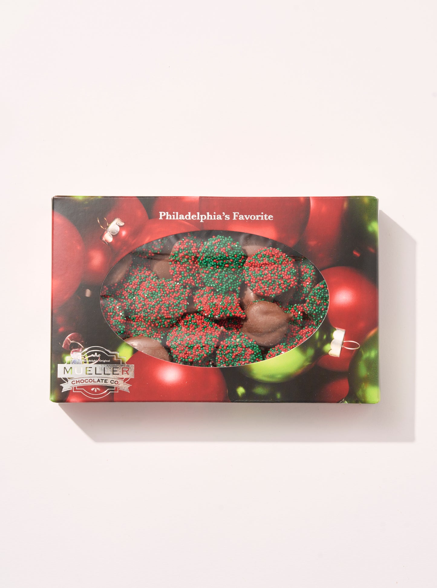 Milk Chocolate Holiday Nonpareils Gift Box with festive red and green sprinkles in holiday-themed packaging.