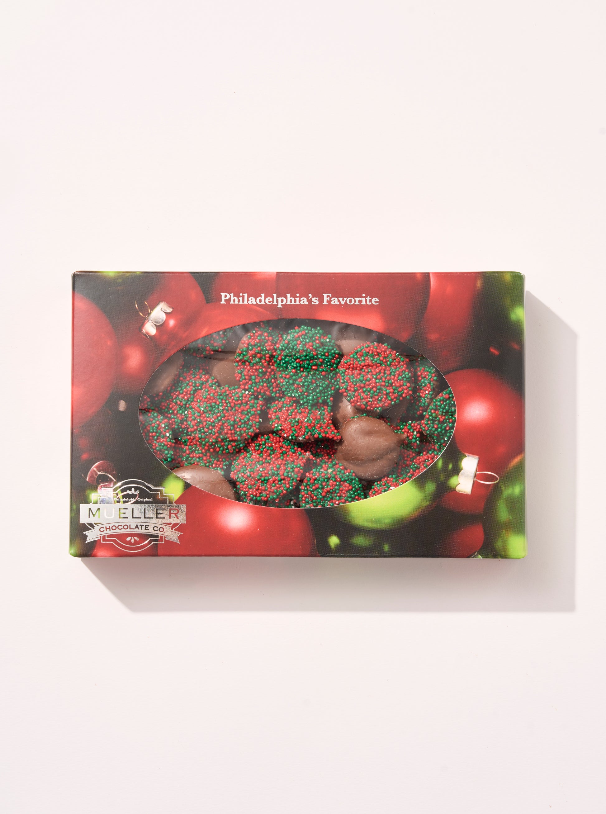 Milk Chocolate Holiday Nonpareils Gift Box with festive red and green sprinkles in holiday-themed packaging.