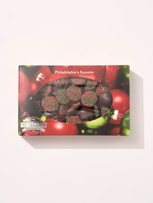 A box of Mueller Chocolate Co.'s Dark Chocolate Holiday Nonpareils, featuring dark chocolate red and green nonpareils